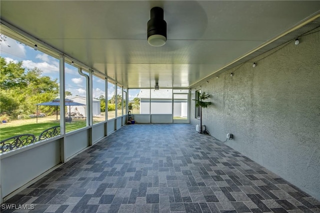 14160 Cedardale St, Fort Myers, FL 33905 - unfurnished sunroom featuring a ceiling fan