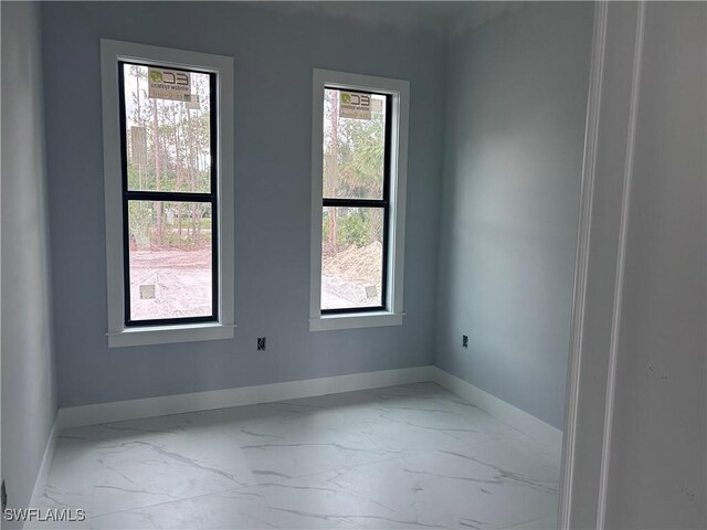 3346 10th Ave SE, Naples, FL 34117 - empty room featuring marble finish floors and baseboards