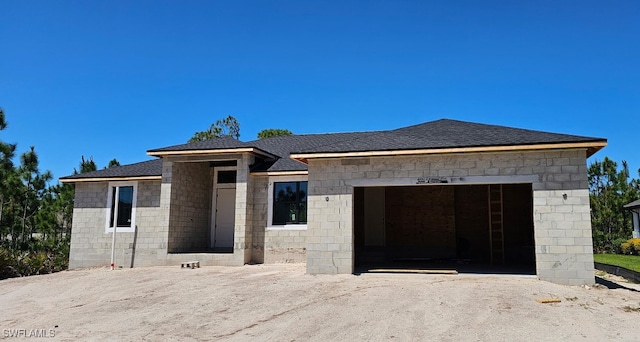 8161 Dressel St, Port Charlotte, FL 33981 - view of front of property with an attached garage, a shingled roof, concrete block siding, and driveway