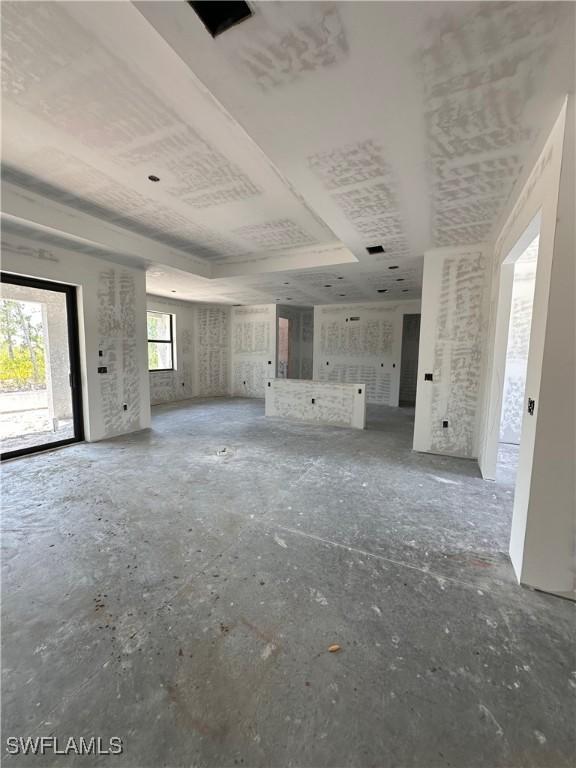 8161 Dressel St, Port Charlotte, FL 33981 - unfurnished living room with a tray ceiling
