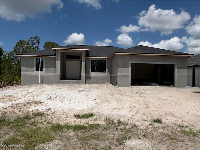 8161 Dressel St, Port Charlotte, FL 33981 - prairie-style house with an attached garage, stucco siding, and driveway
