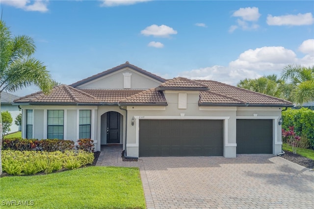 2337 Tangerine Ln, Naples, FL 34120 - mediterranean / spanish house featuring a garage, decorative driveway, stucco siding, a tile roof, and a front yard