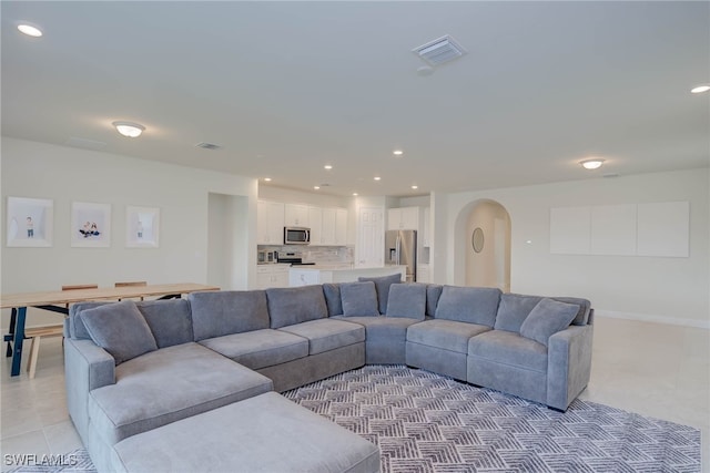 2337 Tangerine Ln, Naples, FL 34120 - living area featuring arched walkways, light tile patterned flooring, recessed lighting, and baseboards