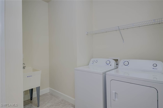 2337 Tangerine Ln, Naples, FL 34120 - laundry area with independent washer and dryer, baseboards, and light marble finish flooring