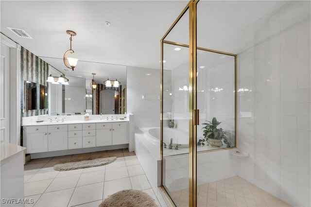 11640 Court Of Palms Unit 103, Fort Myers, FL 33908 - bathroom with double vanity, a garden tub, a shower stall, and tile patterned floors