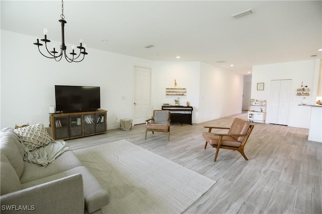 12083 Maiden Ln, Bonita Springs, FL 34135 - living room featuring a chandelier, light wood-style floors, baseboards, and recessed lighting
