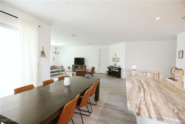 12083 Maiden Ln, Bonita Springs, FL 34135 - dining space with light wood finished floors, a chandelier, and recessed lighting