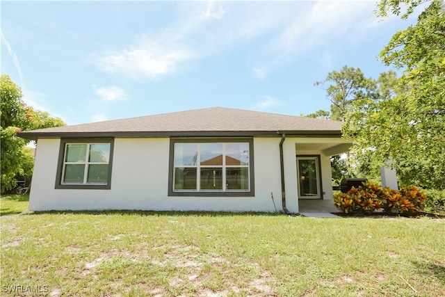 12083 Maiden Ln, Bonita Springs, FL 34135 - view of front of home with stucco siding and a front yard