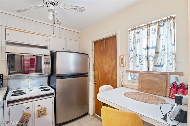 1415 Tropic Ter Unit 1415, North Fort Myers, FL 33903 - kitchen featuring appliances with stainless steel finishes, light countertops, a ceiling fan, and light tile patterned flooring