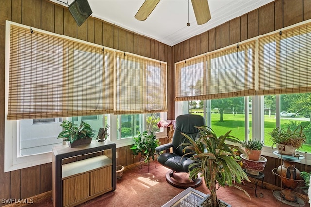 1415 Tropic Ter Unit 1415, North Fort Myers, FL 33903 - sunroom with ceiling fan, carpet flooring, and wood walls