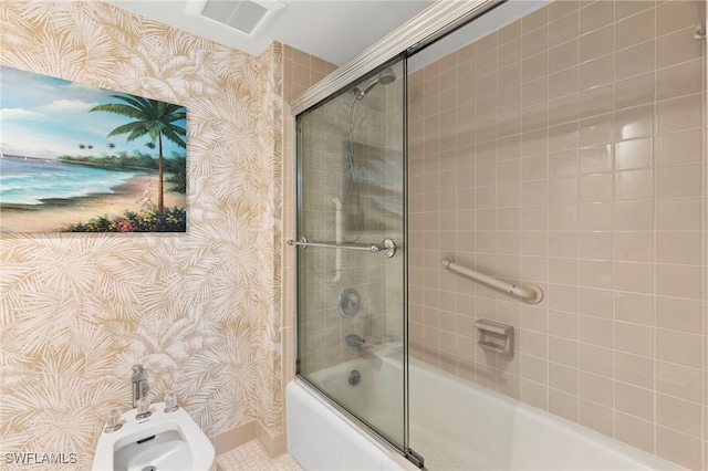1036 S Collier Blvd Unit A103, Marco Island, FL 34145 - full bath with wallpapered walls, enclosed tub / shower combo, baseboards, and a bidet