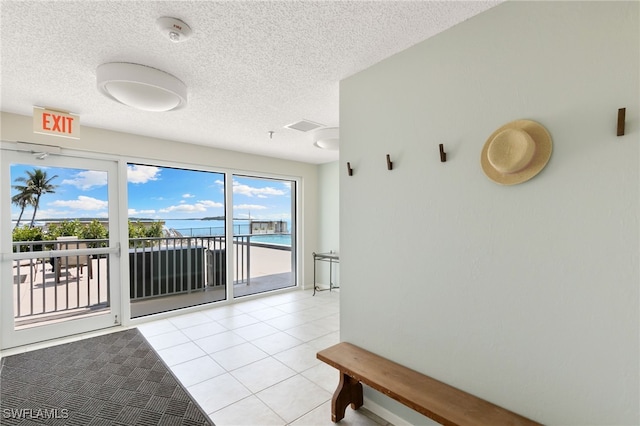 1036 S Collier Blvd Unit A103, Marco Island, FL 34145 - spare room featuring a smoke detector, a textured ceiling, and light tile patterned floors