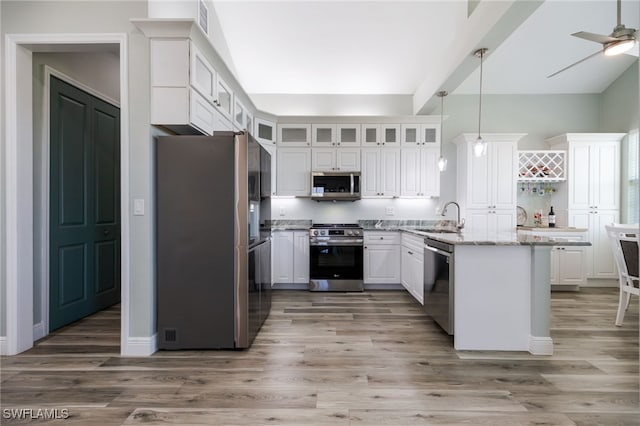 910 Gen George Patton Ave, Labelle, FL 33935 - kitchen featuring appliances with stainless steel finishes, white cabinetry, a peninsula, glass insert cabinets, and beamed ceiling