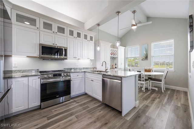 910 Gen George Patton Ave, Labelle, FL 33935 - kitchen featuring appliances with stainless steel finishes, a sink, a peninsula, beamed ceiling, and a ceiling fan