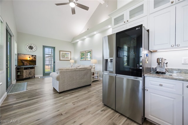 910 Gen George Patton Ave, Labelle, FL 33935 - kitchen featuring stainless steel fridge, ceiling fan, high vaulted ceiling, open floor plan, and light wood finished floors