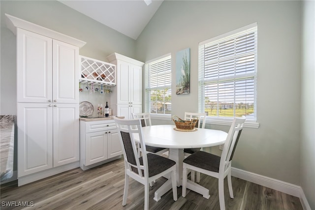 910 Gen George Patton Ave, Labelle, FL 33935 - dining room with a dry bar, lofted ceiling, light wood finished floors, and baseboards