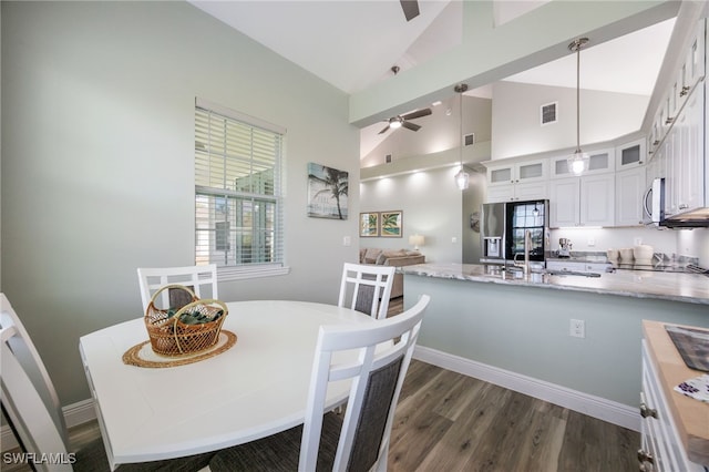 910 Gen George Patton Ave, Labelle, FL 33935 - dining area with a ceiling fan, dark wood finished floors, high vaulted ceiling, and baseboards