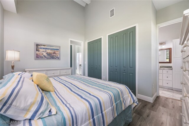 910 Gen George Patton Ave, Labelle, FL 33935 - bedroom with two closets, a high ceiling, baseboards, and connected bathroom