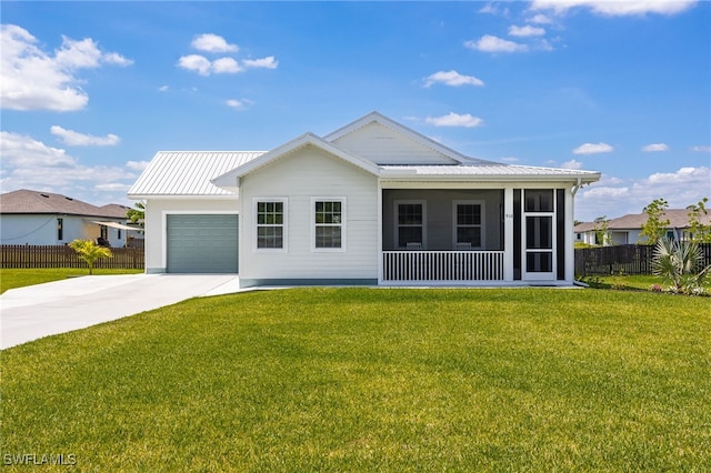 910 Gen George Patton Ave, Labelle, FL 33935 - view of front of property featuring driveway, a garage, metal roof, and a sunroom