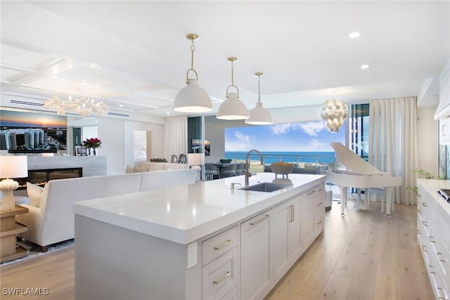 13945 Old Coast Rd Unit 2204, Naples, FL 34110 - kitchen featuring a chandelier, light countertops, light wood-style floors, recessed lighting, and coffered ceiling