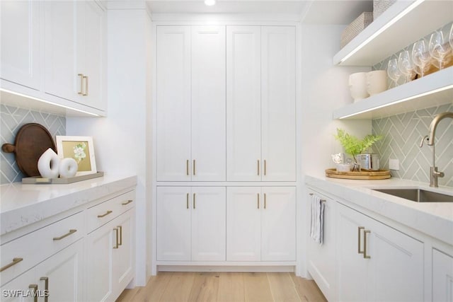 13945 Old Coast Rd Unit 2204, Naples, FL 34110 - bar with backsplash, light wood-type flooring, and recessed lighting