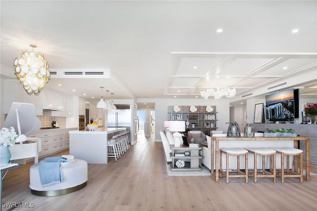 13945 Old Coast Rd Unit 2204, Naples, FL 34110 - living room with a chandelier, light wood-type flooring, coffered ceiling, and recessed lighting