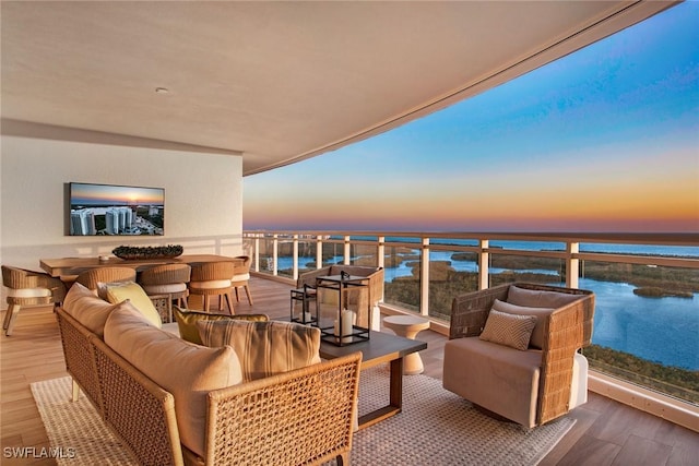 13945 Old Coast Rd Unit 2204, Naples, FL 34110 - balcony at dusk with an outdoor hangout area and a water view