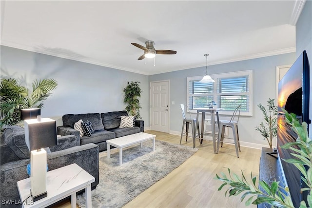 130 N Collier Blvd Unit A7, Marco Island, FL 34145 - living area featuring ceiling fan, light wood-type flooring, baseboards, and ornamental molding
