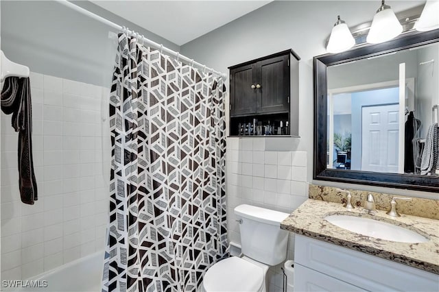 130 N Collier Blvd Unit A7, Marco Island, FL 34145 - bathroom featuring vanity, toilet, tile walls, and shower / tub combo with curtain
