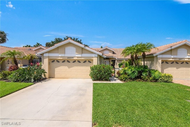 28908 Marsh Elder Ct, Bonita Springs, FL 34135 - single story home with an attached garage, a front lawn, driveway, a tiled roof, and stucco siding