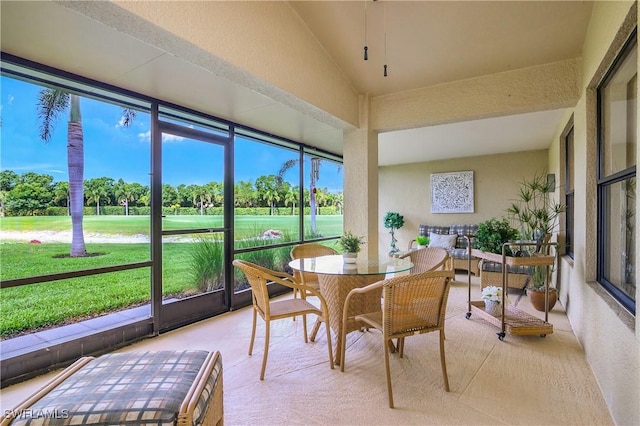 28908 Marsh Elder Ct, Bonita Springs, FL 34135 - sunroom / solarium with view of golf course, healthy amount of natural light, outdoor dining area, vaulted ceiling, and view of scattered trees