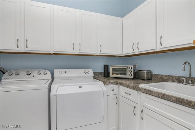 28908 Marsh Elder Ct, Bonita Springs, FL 34135 - laundry area with cabinet space and washer and dryer