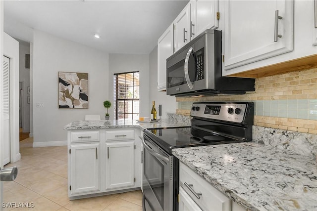 28908 Marsh Elder Ct, Bonita Springs, FL 34135 - kitchen with stainless steel appliances, a peninsula, white cabinets, and backsplash