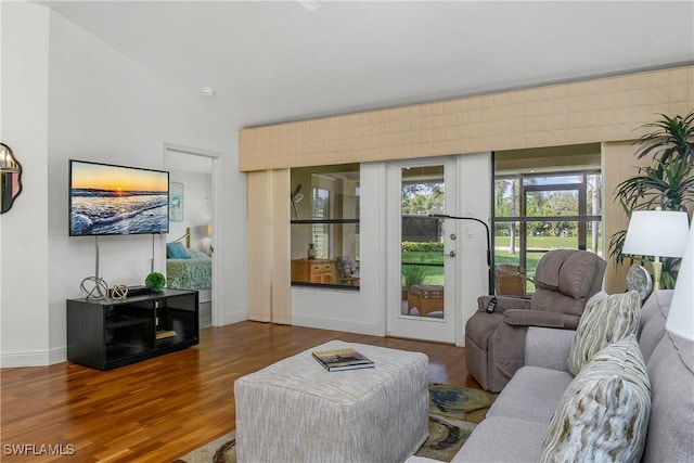 28908 Marsh Elder Ct, Bonita Springs, FL 34135 - living area with wood finished floors, french doors, baseboards, and vaulted ceiling