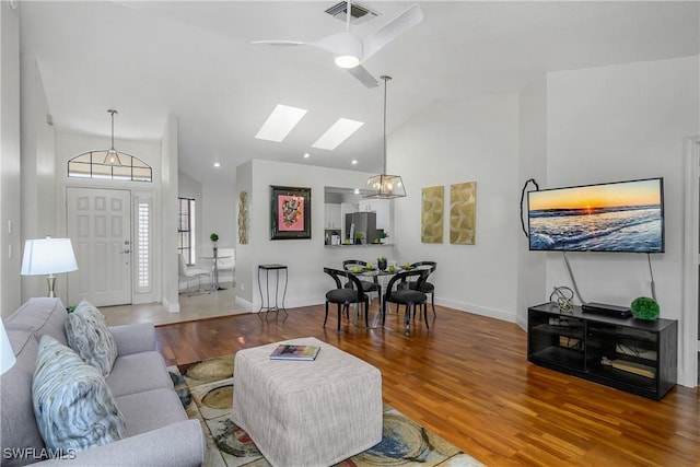 28908 Marsh Elder Ct, Bonita Springs, FL 34135 - living area with a skylight, wood finished floors, baseboards, and high vaulted ceiling