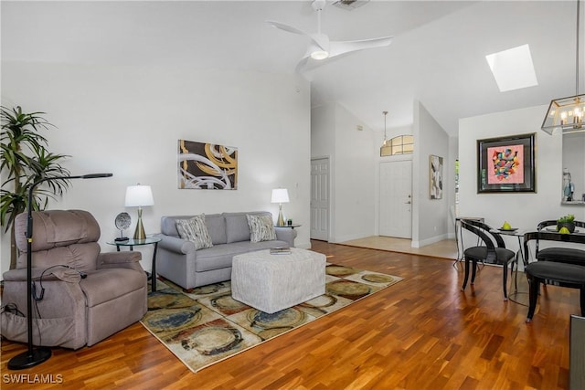 28908 Marsh Elder Ct, Bonita Springs, FL 34135 - living room with a skylight, wood finished floors, high vaulted ceiling, and ceiling fan