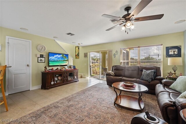 15120 Piping Plover Ct Unit 102, North Fort Myers, FL 33917 - living area with light tile patterned flooring, a ceiling fan, and baseboards