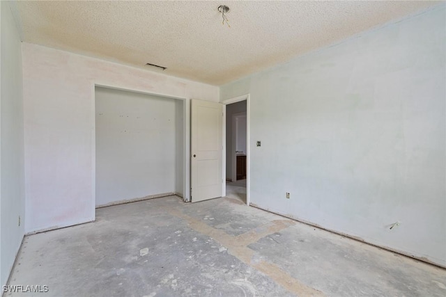 8172 Sanibel Blvd, Fort Myers, FL 33967 - unfurnished bedroom featuring a textured ceiling and a closet