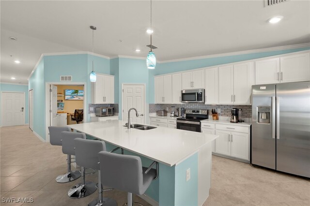 15960 Grassland Ln Unit 2726, Punta Gorda, FL 33982 - kitchen featuring appliances with stainless steel finishes, a sink, crown molding, tasteful backsplash, and a kitchen breakfast bar
