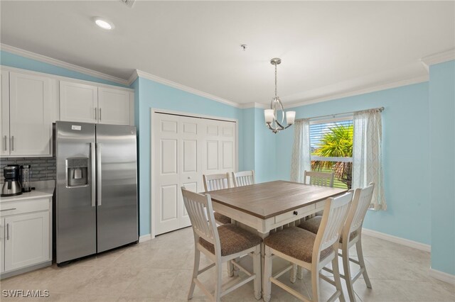 15960 Grassland Ln Unit 2726, Punta Gorda, FL 33982 - dining space with a chandelier, baseboards, crown molding, and light tile patterned floors