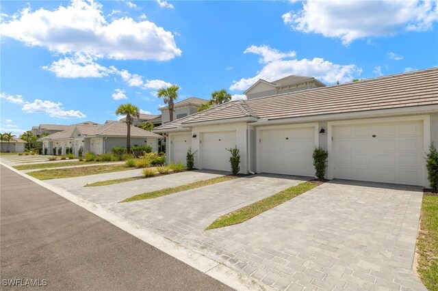 15960 Grassland Ln Unit 2726, Punta Gorda, FL 33982 - view of property with a tile roof, community garages, a residential view, and stucco siding