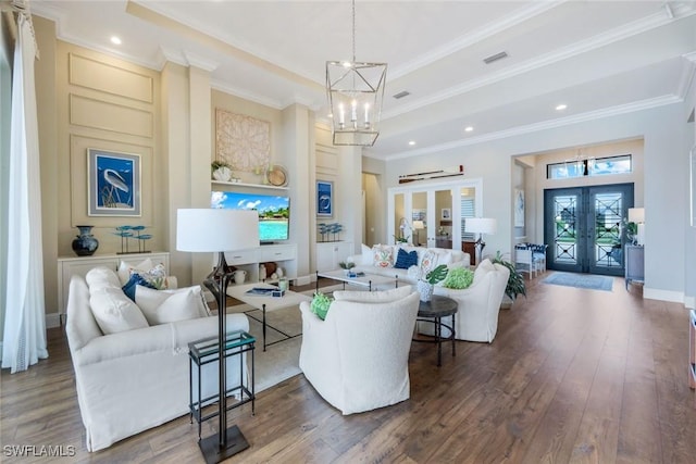 9010 Arrezo Ct, Naples, FL 34119 - living area with french doors, a chandelier, wood finished floors, crown molding, and recessed lighting