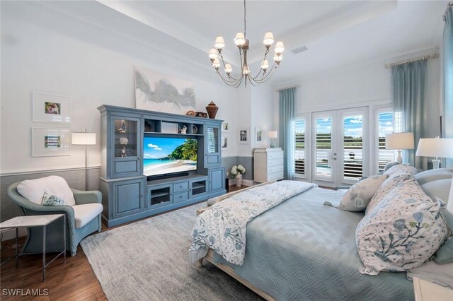 9010 Arrezo Ct, Naples, FL 34119 - bedroom featuring a chandelier, access to exterior, and wood finished floors