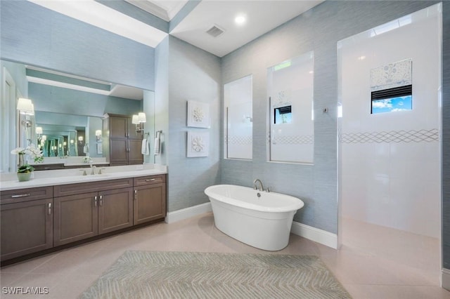 9010 Arrezo Ct, Naples, FL 34119 - full bathroom featuring tile patterned floors, a freestanding bath, vanity, and walk in shower