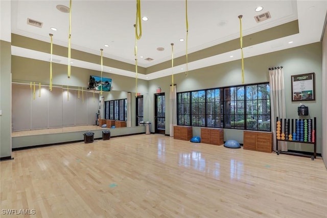 9010 Arrezo Ct, Naples, FL 34119 - exercise room with a towering ceiling, crown molding, wood finished floors, a raised ceiling, and recessed lighting