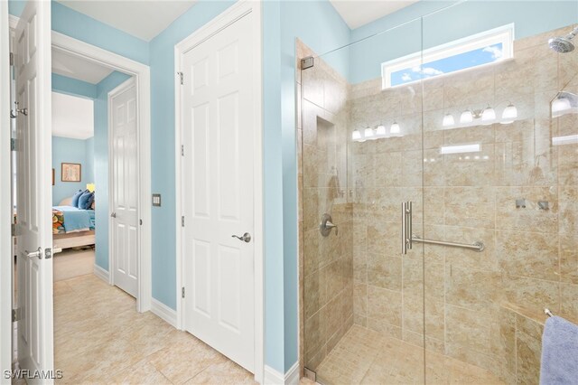 14687 Topsail Dr, Naples, FL 34114 - full bathroom with a shower stall, ensuite bath, baseboards, and tile patterned floors
