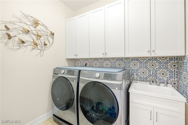 14687 Topsail Dr, Naples, FL 34114 - washroom with cabinet space, separate washer and dryer, and baseboards