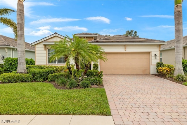 14687 Topsail Dr, Naples, FL 34114 - view of front of home with an attached garage, decorative driveway, a front yard, and a tiled roof