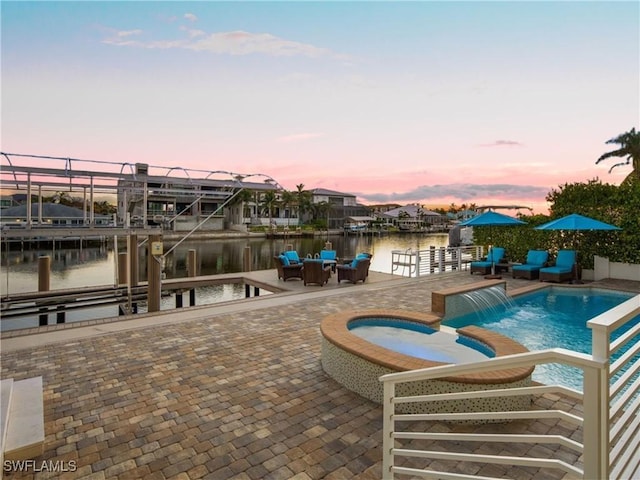 434 Conners Ave, Naples, FL 34108 - view of swimming pool with a water view, boat lift, a pool with connected hot tub, a dock, and a patio area