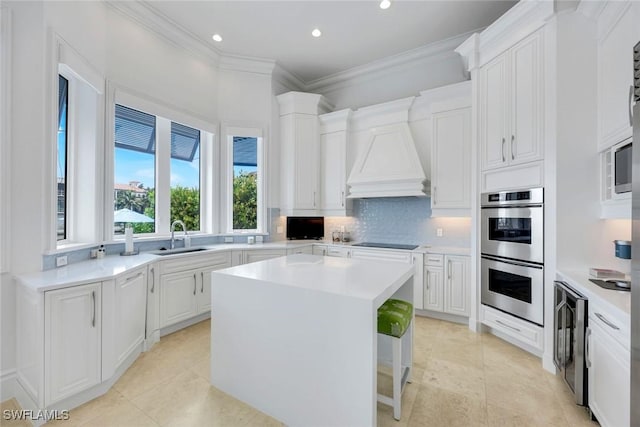 434 Conners Ave, Naples, FL 34108 - kitchen featuring stainless steel double oven, a kitchen island, backsplash, recessed lighting, and custom exhaust hood